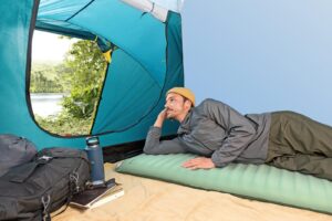 Κατασκηνωτής ξαπλωμένος στο υπόστρωμα Bestway Comfortrek μέσα σε σκηνή